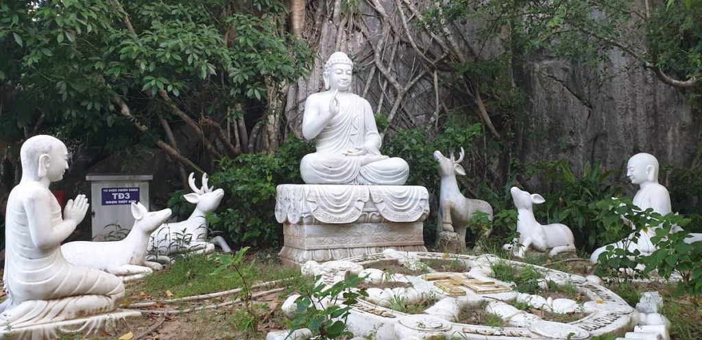 Monks and animals with Buddha on marble mountains in Da Nang, Vietnam.